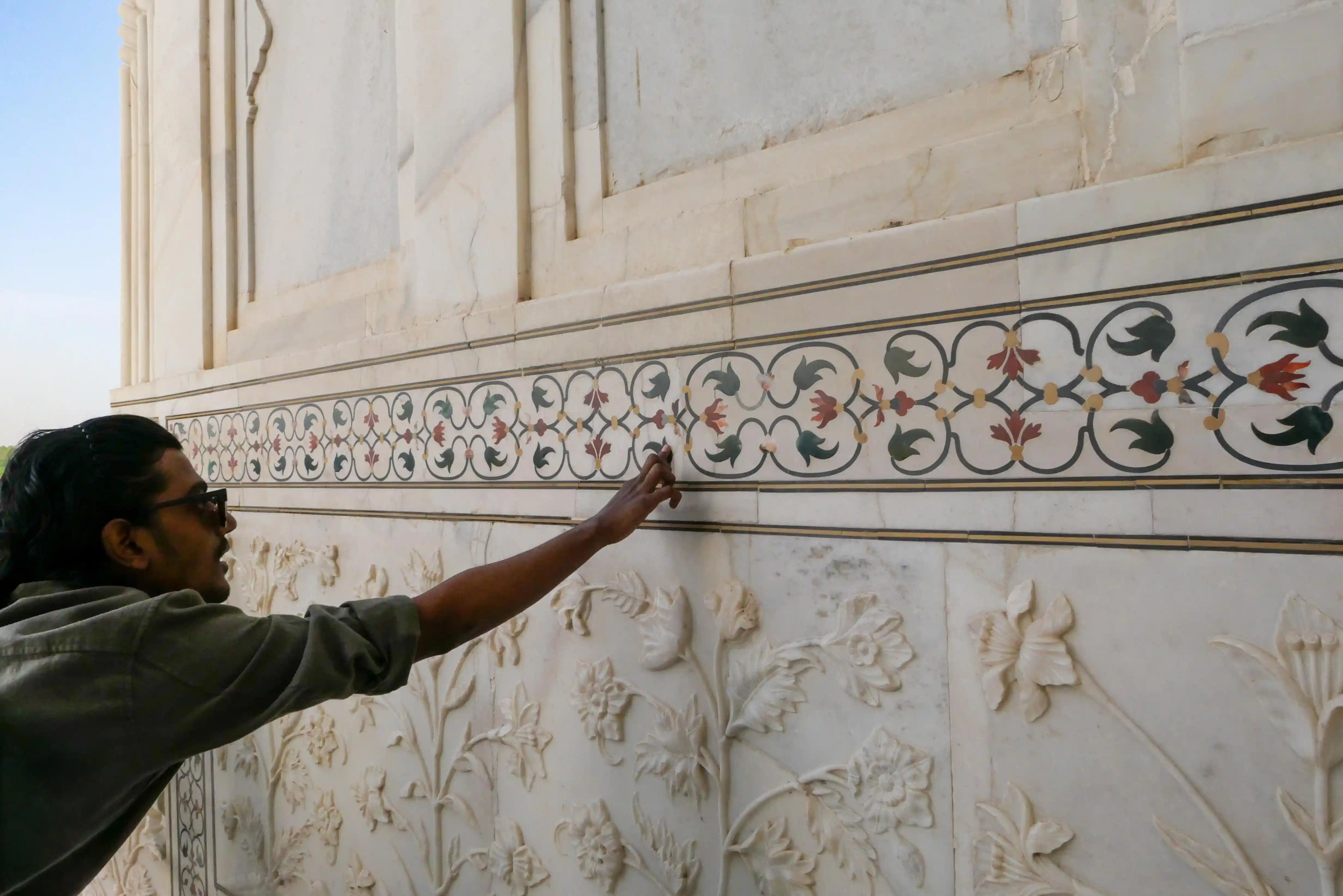 Visitors exploring the Taj Mahal grounds and mausoleum platform