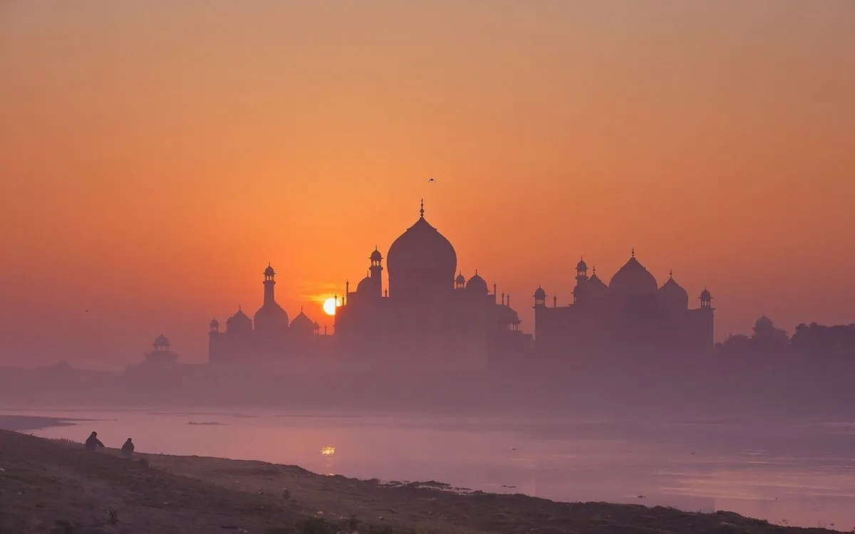 The Taj Mahal at sunrise across the Yamuna river, in morning haze