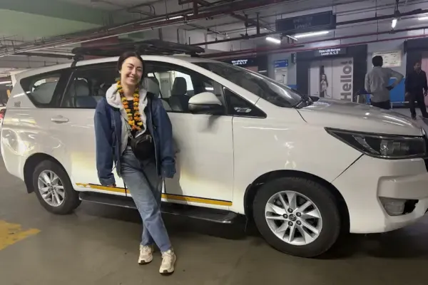 A traveller beside the private car used for a Golden Triangle tour