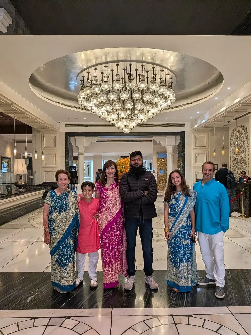 A family group with their guide in a hotel lobby in Agra